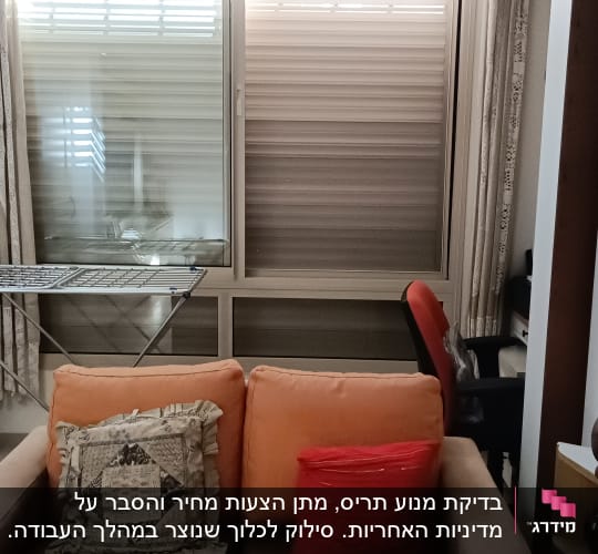 סלון עם ספה ותריסים סגורים בחלון